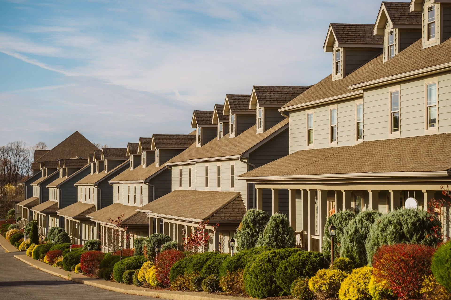 A street of row houses with tidy front gardens